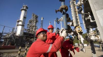 Operarios trabajan en la extractora de petróleo de Puerto La Cruz, ciudad de Anzoátegui, Venezuela. En junio de 2014, el crudo costaba $104 el barril, hoy vale menos de $50.