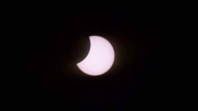 The moon partially covers the sun as seen from Piedra del Aquila, Neuquen province, Argentina on December 14, 2020. (Photo by RONALDO SCHEMIDT / AFP)