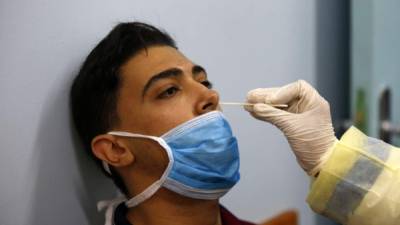 A hospital staff gets tested for coronavirus in Rafah in the southern Gaza Strip on August 31, 2020, amid a lockdown in the Palestinian enclave due to increasing cases of COVID-19 infections. (Photo by SAID KHATIB / AFP)