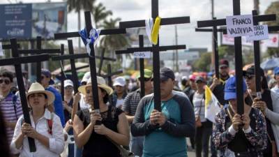 Jóvenes fueron registrados este viernes al protestar contra el presidente de Nicaragua, Daniel Ortega, durante el viacrucis de Semana Santa, en Managua (Nicaragua). EFE