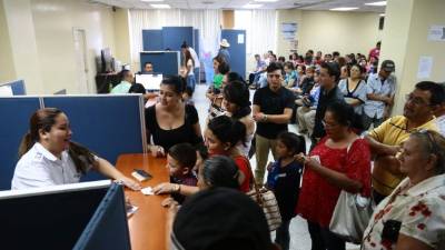 Solicitantes mientras esperan que se les entreguen el pasaporte. Foto: Franklyn Muñoz.