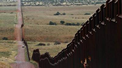 (FILES) In this file photo taken on January 6, 2019 a section of the reinforced US - Mexico border fence on the Otay Mesa area, San Diego County, as seen from Tijuana, in Baja California state, Mexico. - Facing stiff resistance from Congress, President Donald Trump has said he might use his emergency powers to construct hundreds of miles of wall on the southern border to prevent migrants from crossing into the United States illegally from Mexico. Trump could indeed declare a national emergency, citing what the administration calls a 'crisis' at the border, after nearly 103,000 people were detained in October and November after entering the country illegally.But trying to build a wall in this way would face significant legal barriers. (Photo by Guillermo Arias / AFP)