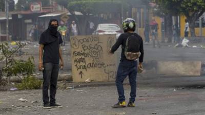 Dos jóvenes resguardan una barricada en los alrededores de la Universidad Politécnica de Nicaragua (UPOLI) hoy, 23 de abril de 2018, en Managua (Nicaragua). EFE