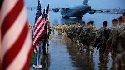 In this image released by the US Defense Department, 82nd Airborne paratroopers march to board a civilian aircraft bound for the US Central Command area of operations from Fort Bragg, North Carolina, on January 4, 2020. - This deployment is a precautionary action taken to respond to increased threat levels against US personnel and facilities. Thousands more US troops were ordered to the Middle East on January 3 after the US assassinated Iran's military mastermind and Tehran promised 'severe revenge.' (Photo by Hubert Delaney III / US Department of Defense / AFP) / RESTRICTED TO EDITORIAL USE - MANDATORY CREDIT 'AFP PHOTO / US Army Photo / US Army / Spc. Hubert Delaney III' - NO MARKETING - NO ADVERTISING CAMPAIGNS - DISTRIBUTED AS A SERVICE TO CLIENTS