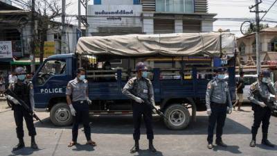 Policías en Birmania se protegen con una mascarilla para evitar el contagio del coronavirus. Foto: AFP