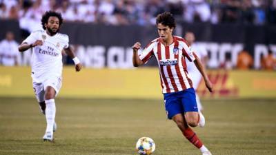 Real Madrid's Brazilian defender Marcelo (L) runs after Atletico Madrid's Portuguese midfielder Joao Felix as he controls the ball during their 2019 International Champions Cup football match between Real Madrid and Atletico Madrid at the Metlife Stadium Arena in East Rutherford, New Jersey on July 26, 2019. (Photo by Johannes EISELE / AFP)