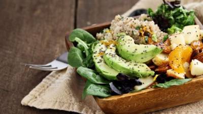 Quinoa, avocado and apple salad. Perfect for the detox diet or just a healthy meal. Selective focus on front of dish with extreme shallow depth of field.