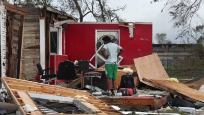 LAKE CHARLES, LOUISIANA - AUGUST 27: James Sonya surveys what is left of his uncles barber shop after Hurricane Laura passed through the area on August 27, 2020 in Lake Charles, Louisiana . The hurricane hit with powerful winds causing extensive damage to the city. Joe Raedle/Getty Images/AFP== FOR NEWSPAPERS, INTERNET, TELCOS & TELEVISION USE ONLY ==