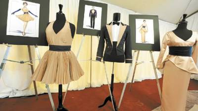 Outfits for cocktail waitresses (L), waiters (C) and the orchestra (R) are on display at the preview of the food and beverages of the Governors Ball, the celebration immediately following the 82nd Academy Awards, on the red carpet in front of the Kodak Theatre in the Hollywood section of Los Angeles, California on March 4, 2010. The 82nd Annual Academy Awards will be held on March 7, 2010 at the Kodak Theatre. AFP PHOTO / Robyn BECK