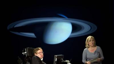 (FILES) In this file photo taken on April 21, 2008, British physicist Stephen Hawking (L) and his daughter Lucy Hawking give a lecture entitled 'Why We Should Go Into Space' during the 50 Years of NASA lecture series at George Washington University in Washington, DC.Renowned British physicist Stephen Hawking, whose mental genius and physical disability made him a household name and inspiration across the globe, has died at age 76, a family spokesman said on March 14, 2018. / AFP PHOTO / Jim WATSON