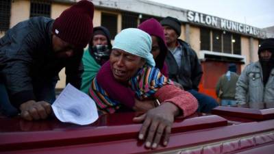 Familiares de las víctimas en un salón municipal donde velan a sus parientes. AFP