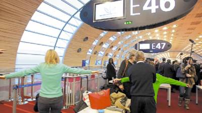Passengers are frisked as part of increased security measures during a visit of France's Interior, Overseas Departments and Territorial Administration Minister Brice Hortefeux, at Roissy-Charles-de-Gaulle airport, North of Paris, on December 30, 2009. The new security measures were implemented after a Nigerian man, Umar Farouk Abdulmutallab, attempted a terrorist attack on a Northwest Airlines flight on Christmas Day before landing in Detroit on a flight from Amsterdam. AFP PHOTO / PIERRE VERDY
