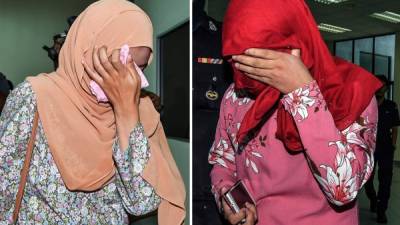 Una pareja de mujeres malasias que recibieron hoy seis azotes cada una tras ser condenadas por tratar de mantener relaciones homosexual. EFE