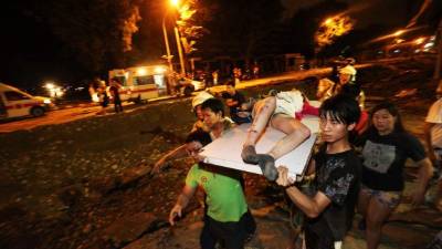 A worker pulls a wheelbarrow at the Jardines del Humaya cemetery, known due to its mausoleums, where drug traffickers are buried, that count with luxuries and services such as air conditioning and bulletproof glass in Culiacan, Mexico, on July 15, 2019. - An air of sarcasm travels through Sinaloa, birthplace of the legendary Mexican drug lord Joaquin 'El Chapo' Guzman, before the imminent sentence of life imprisonment that he will receive this Wednesday in the United States. Inhabitants of this arid region who consider him their benefactor assure that neither the violence nor drug trafficking will diminish. (Photo by Pedro PARDO / AFP)