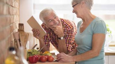 Modern senior couple spending time in the kitchen