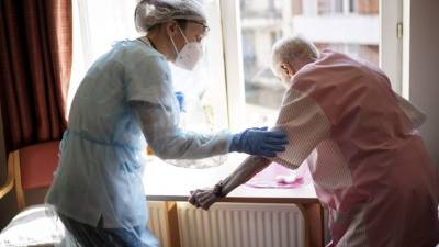 Una enfermera ayuda a una anciana en Bélgica. Foto AFP/Referencial