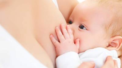 breastfeeding. mother holding newborn baby in an embrace and breastfeed