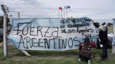 Women write a message in support to the 44 missing submariners, outside Argentina's Navy base in Mar del Plata, on the Atlantic coast south of Buenos Aires, on November 20, 2017. Argentina's navy revealed Monday that a submarine missing for five days reported a mechanical breakdown in its final communication, and that weekend signals did not come from the vessel, dimming hopes for its 44 crew members. / AFP PHOTO / EITAN ABRAMOVICH