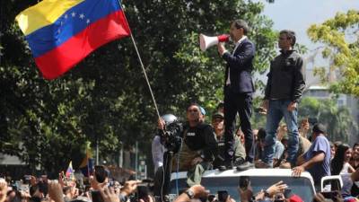 El presidente de la Asamblea Nacional, Juan Guaidó (c-i), y el líder opositor Leopoldo López participando ayer en una manifestación en apoyo a su levantamiento contra el gobierno de Nicolás Maduro en Caracas, Venezuela. EFE
