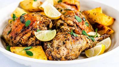 Disfrute el delicioso pollo al estilo griego con rebanas de limón encima.