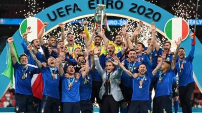 Italy's defender Giorgio Chiellini raises the European Championship trophy during the presentation after Italy won the UEFA EURO 2020 final football match between Italy and England at the Wembley Stadium in London on July 11, 2021. (Photo by Michael Regan / POOL / AFP)