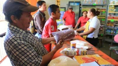 Tres personas en tienda Banasupro. Foto: Jordan Perdomo.