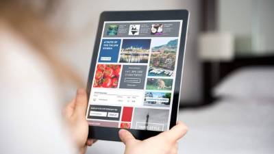 The photo was taken indoors in a domestic room by photographing over the model's shoulder. There is a website visable on the device screen. I own the copyright to the website design and the copyright of all photos shown on the screen.