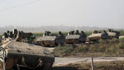 Maniobra de vehículos blindados de transporte de personal (APC) ‘Namer’ de las FDI en una zona a lo largo de la frontera con Gaza, sur de Israel, 13 de octubre de 2023.