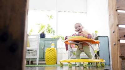 Baby girl playing in walker