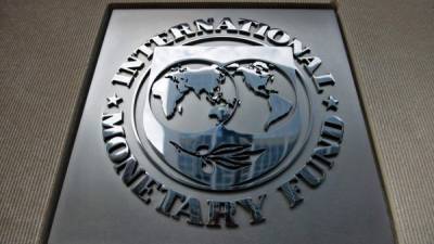 (FILES) This file photo taken on June 30, 2015 shows the IMF logo seen outside the headquarters of the International Monetary Fund in Washington, DC. The lack of details on President Donald Trump's plans to reform the US economy prompted the International Monetary Fund on June 27, 2017 to cut its growth forecast for this year and next.The IMF in January raised the estimates on the expectation of fiscal stimulus from the Trump administration, but have reverted back to the previous calculations -- which project the economy to expand by 2.1 percent in 2017 and 2018, down from 2.3 percent and 2.5 percent, respectively. / AFP PHOTO / BRENDAN SMIALOWSKI