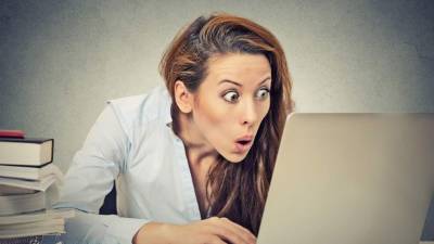 Fresh avocado on cutting board over wooden background