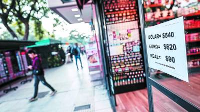 Una tienda en Argentina muestra los precios de las divisas en una de sus ventanas.