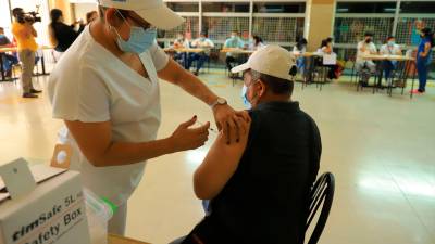 Una enfermera inyecta el biológico contra el covid a un ciudadano en la terminal de buses. Foto: Melvin Cubas.