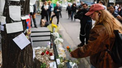 Fotografía de archivo de una mujer que coloca flores frente al hotel de Buenos Aires (Argentina) donde falleció el exintegrante de la banda One Direction, Liam Payne.
