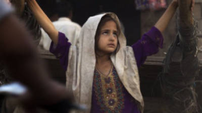 A displaced Pakistani girl from the tribal area of Bajur due to fighting between security forces and militants, stands outside a make-shift shop in slums of Islamabad, Pakistan, Monday, Oct. 8, 2012. (AP Photo/B.K. Bangash)