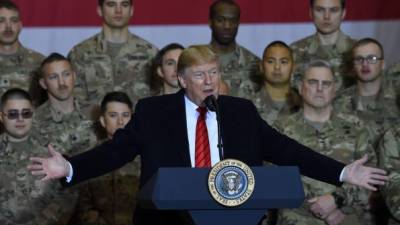 US President Donald Trump speaks to the troops during a surprise Thanksgiving day visit at Bagram Air Field, on November 28, 2019 in Afghanistan. (Photo by Olivier Douliery / AFP)