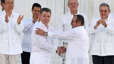 Santos y Timochenko se saludan tras la firma del acuerdo de paz.