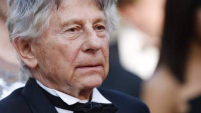 (FILES) In this file photo taken on November 04, 2019 French Polish director Roman Polanski looks on on stage after the preview of his last movie 'J'accuse' (An Officer and a Spy) in Paris. - Roman Polanski's new film 'An Officer and a Spy' topped the list of nominations on Wednesday for the 'French Oscars', the Cesars. The controversial director has been wanted in the US for the statutory rape of a 13-year-old girl since 1978 and is persona non grata in Hollywood. His period drama about the Dreyfus affair, which rocked France at the turn of the 20th century, is in line for 12 prizes. The head of the French film academy Alain Terzian said it 'should not take moral positions' about giving awards. (Photo by Thomas SAMSON / AFP)