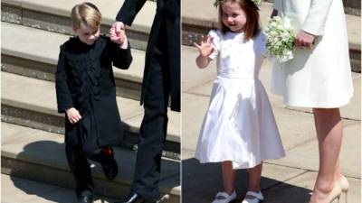 Princess Charlotte of Cambridge (L) stands on the steps holding the hand of her mother Britain's Catherine, Duchess of Cambridge, (R) after attending the wedding ceremony of Britain's Prince Harry, Duke of Sussex and US actress Meghan Markle at St George's Chapel, Windsor Castle, in Windsor, on May 19, 2018. / AFP PHOTO / POOL / Jane Barlow