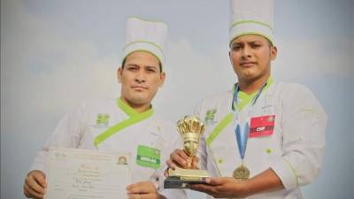 Noé Cruz y Walter Nájera, alumnos de la Academia Cristina Centroamericana de Gastronomía (A.C.E.G.A) muestran los premios que ganaron en el Festival Gastronómico Internacional organizado por la Cámara de Comercio salvadoreña en San Salvador. EFE