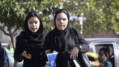 Iranian women cheer during the friendly football match between Iran and Bolivia at the Azadi Stadium in Tehran on October 16, 2018. (Photo by STR / AFP)