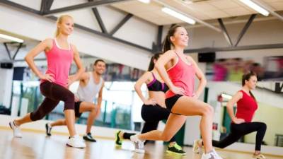 fitness, sport, training, gym and lifestyle concept - group of smiling people exercising in the gym