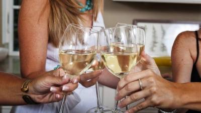 A group of women make a toast during a party.