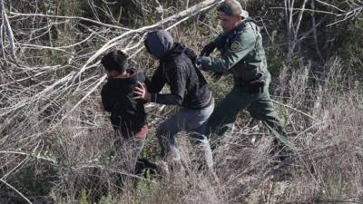 Agentes de la patrulla fronteriza capturan a dos jóvenes indocumentados en la frontera entre Texas y México.