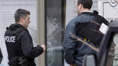 Police investigate outside the scene of a shooting Tuesday, Jan. 15, 2013, in St. Louis. Police say a gunman walked into the Stevens Institute of Business and Arts business school in downtown St. Louis and shot an administrator in the chest before shooting himself. (AP Photo/Jeff Roberson)