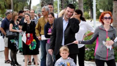 People stand on line to vote on Election Day at the Surfside Town Hall in Miami, Tuesday, Nov. 6, 2012. (AP Photo/El Nuevo Herald, David Santiago) MAGS OUT