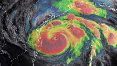 This August 25, 2017, blended visible/infrared image of Hurricane Harvey obtained from The National Oceanic and Atmospheric Administration shows the storms eye as it nears landfall in the southeastern coast of Texas.Harvey has intensified into a powerful category three storm, US meteorologists said on August 25, as the Gulf Coast states of Texas and Louisiana braced for the first major hurricane to hit land since 2005. Harvey, which is set to make landfall late Friday into early Saturday, was packing maximum sustained winds of close to 120 miles (195 kilometers) per hour, the National Hurricane Center said. / AFP PHOTO / NOAA / HO / RESTRICTED TO EDITORIAL USE - MANDATORY CREDIT 'NOAA' - NO MARKETING NO ADVERTISING CAMPAIGNS - DISTRIBUTED AS A SERVICE TO CLIENTS