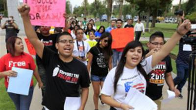 FILE - In this Aug. 16, 2012 file photo, Joshua Montano, left, and Deborah Robles protest in front of the Capitol the day after Arizona Gov. Jan Brewer, in an executive order reaffirming Arizona state law denying young illegal immigrants driver's licenses and other public benefits in Phoenix. Organizations that advocate for immigrant rights on Thursday, Nov. 29, 2012 filed a lawsuit seeking to reverse an order by Jan Brewer that denies driving licenses to young immigrants who have obtained work permits and avoided deportation thanks to a new policy of President Barack Obama. The lawsuit alleges that Arizona's order actually classifies called 'dreamers' as immigrants without permission to reside in the United States. The organizations asked a federal judge to declare unconstitutional the order because federal law takes precedence and because it denies licenses without a valid excuse. (AP Photo/Ross D. Franklin, File)