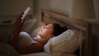 Cropped shot of an attractive young woman using her tablet in bed