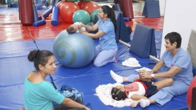 Rehabilitación. Especialistas realizan terapia con dos niños con discapacidad.